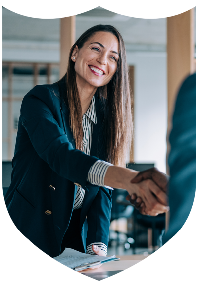 An online MEd student shakes hands with a colleague